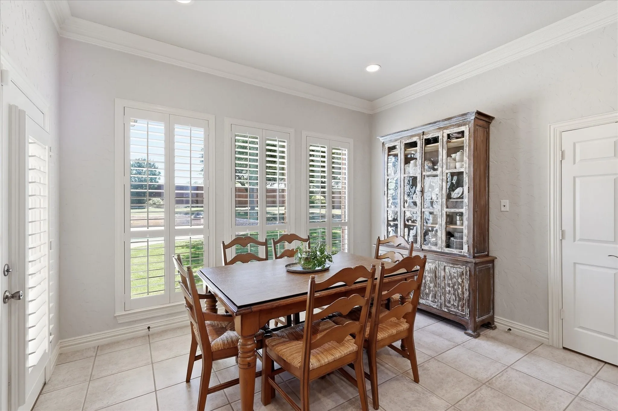 The dining area. Spacious. With plantation shutters too and with exit to backyard.