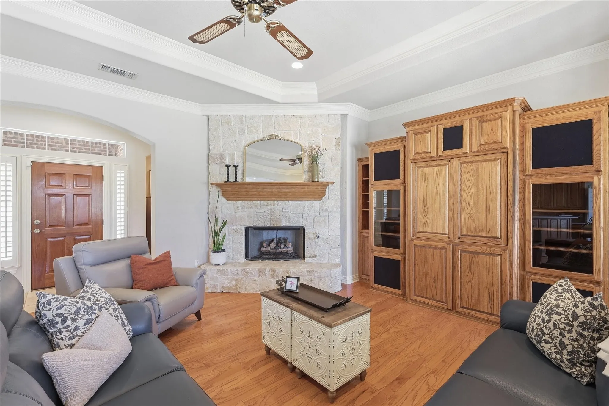 And straight ahead the inviting living room with wood floors and cozy fireplace surrounded by stone.