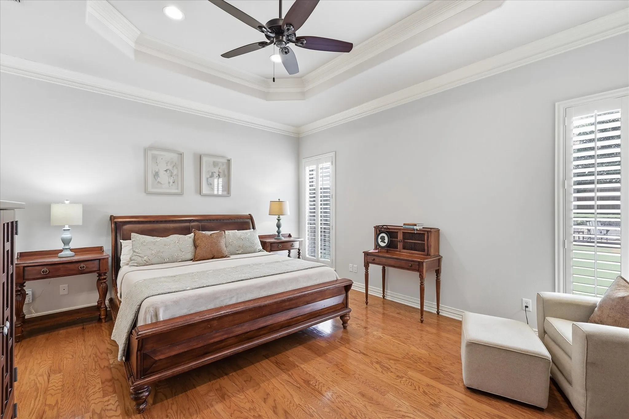 Ceiling fan, windows with plantation shutters looking out onto the serene backyard. Light & bright.