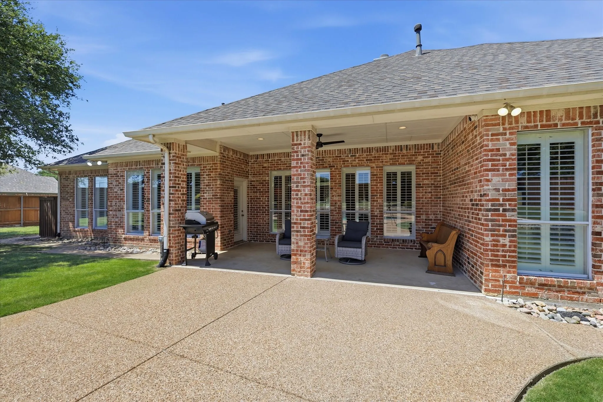 A view of the back of the home and a glimpse into the spacious backyard