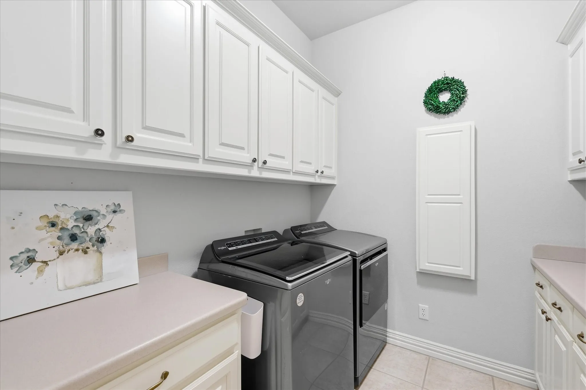 Spacious. Room for side by side washer & dryer. Lots of cabinetry, counterspace and a pull down ironing board. Washer & Dryer do not convey.
