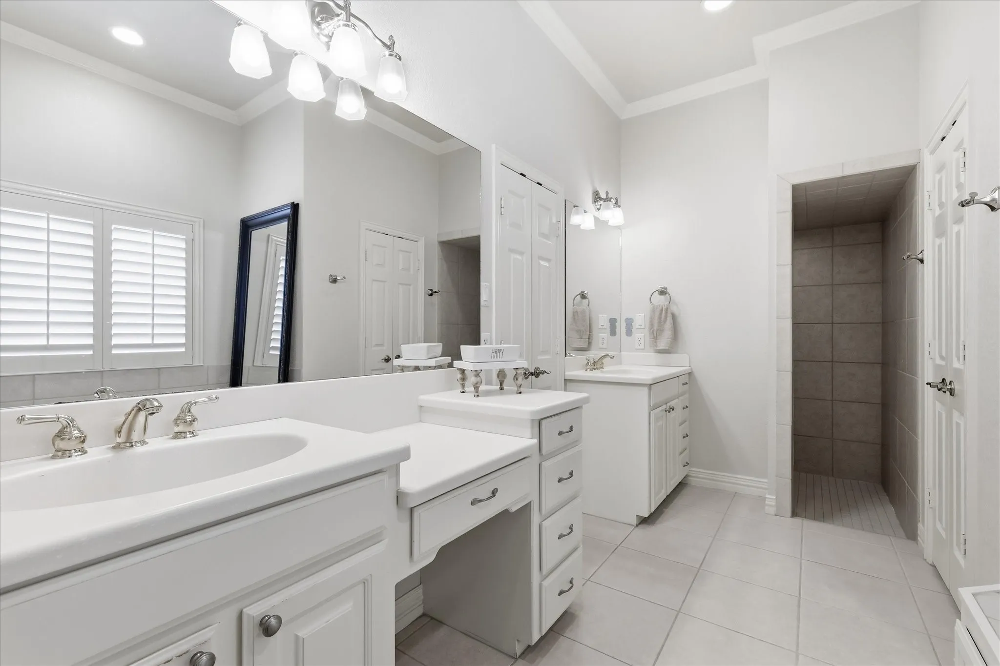 Separate vanities. Lots of mirrors. In between, entry to closet with built ins