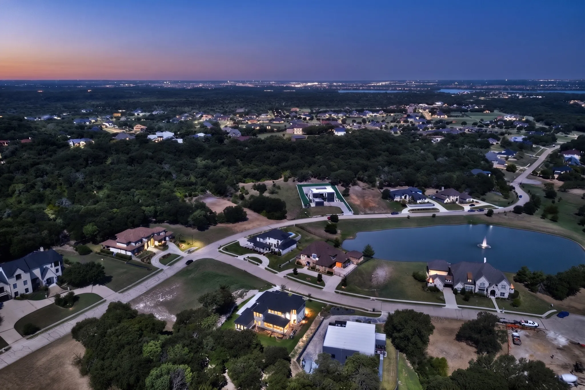 Aerial perspective showcasing a residential community with abundant mature trees and curving roadways