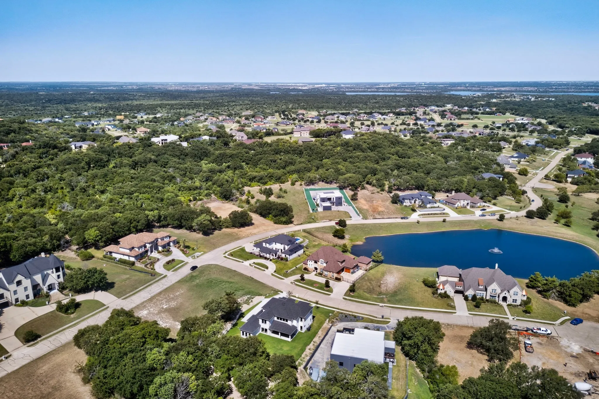 Expansive aerial showcasing a residential community with abundant green spaces