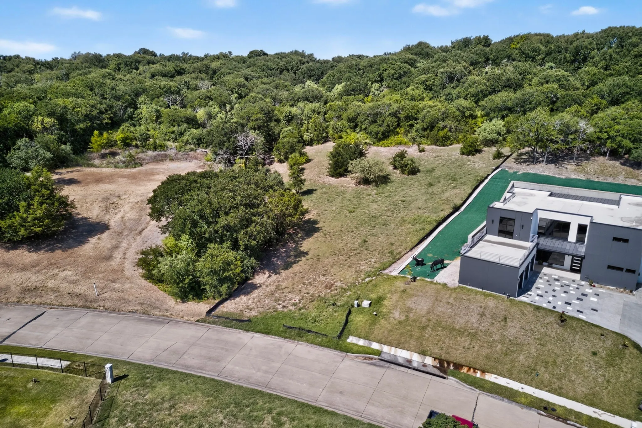 Spacious lot featuring mature trees and a sloped terrain