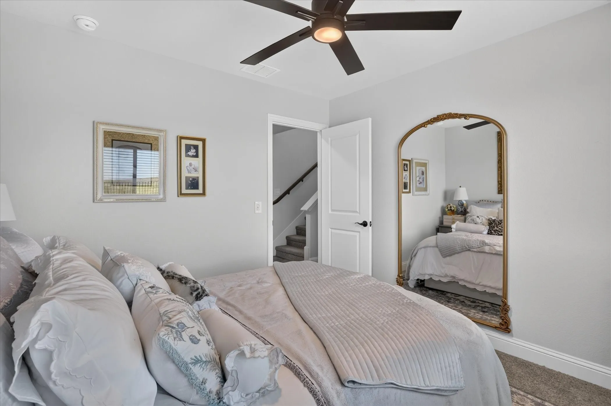 Carpeted room featuring light gray walls and a ceiling fan with integrated lighting