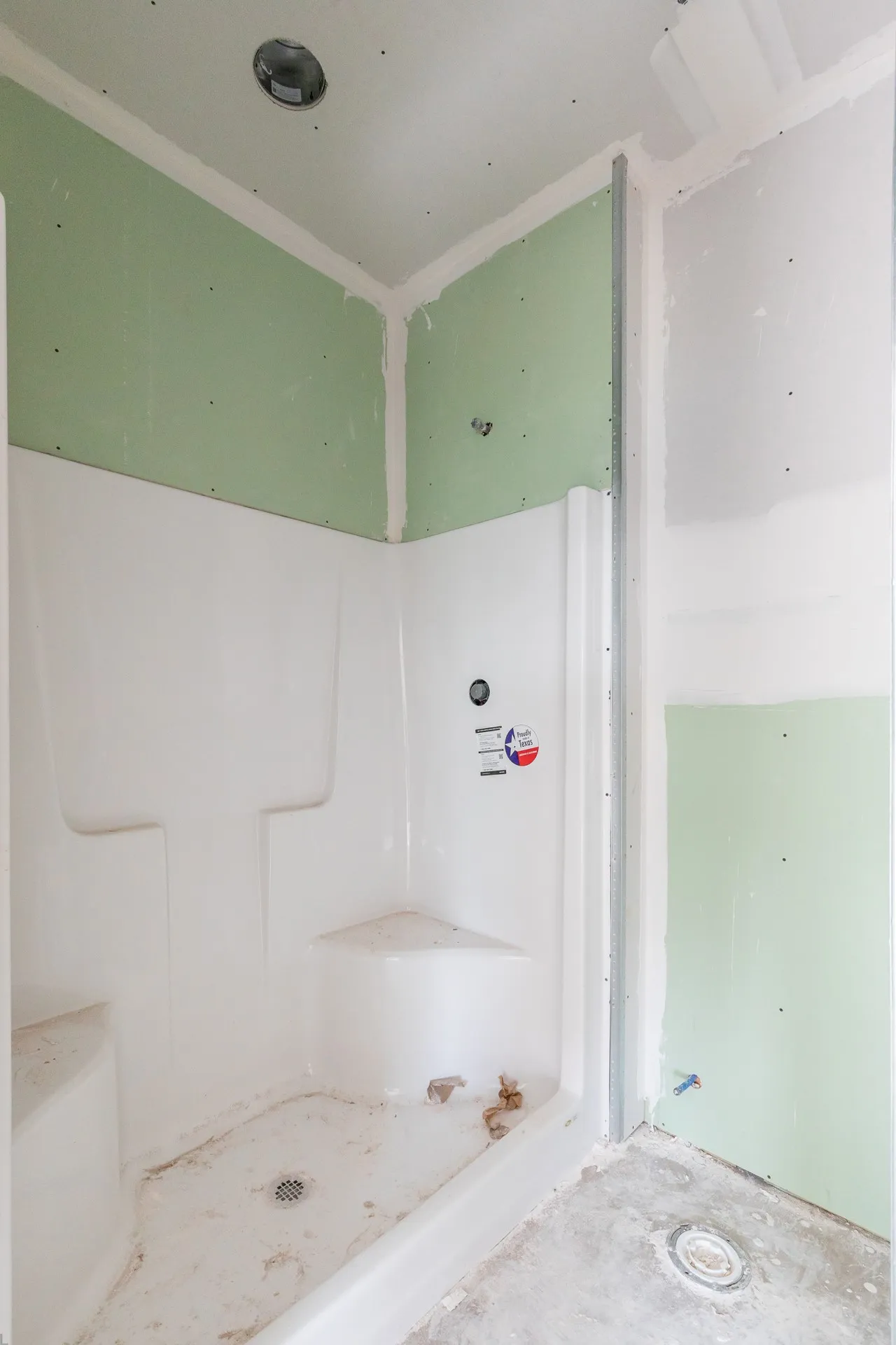White pre-fabricated shower unit with integrated seating