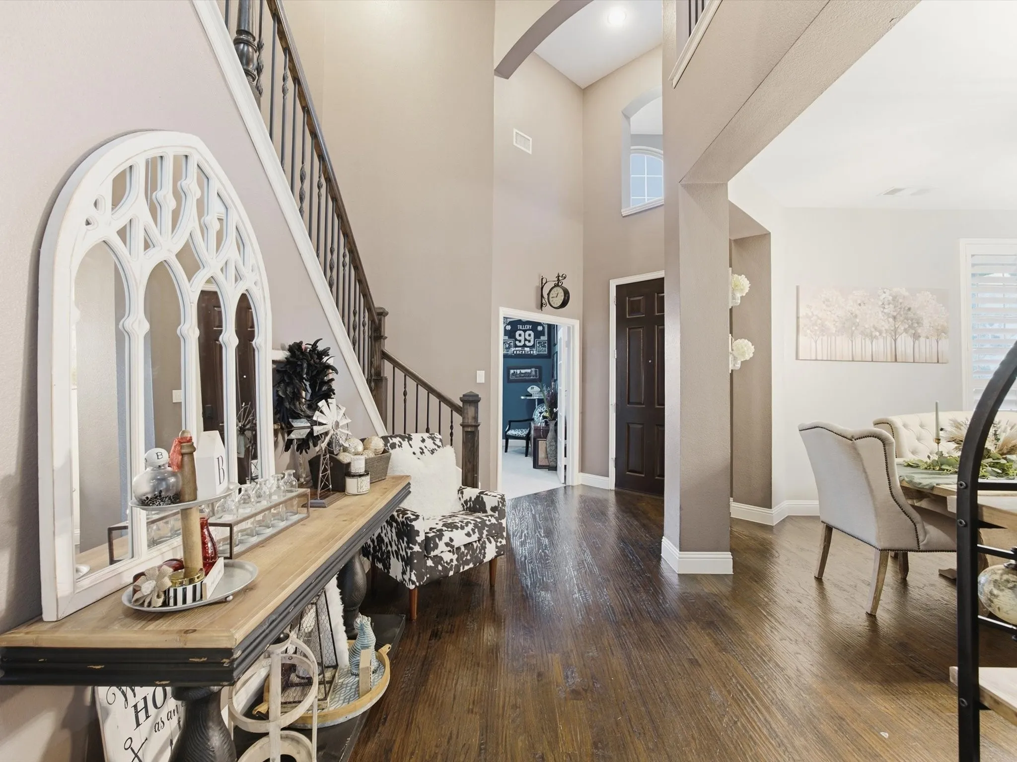 Grand entryway featuring a two-story ceiling and wood-finish flooring