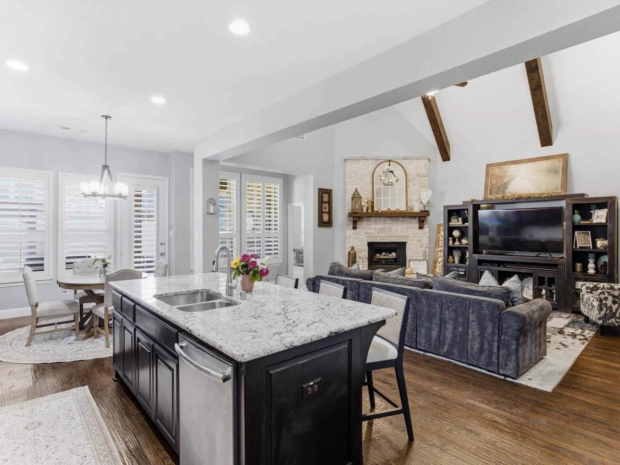Kitchen island featuring a double-basin sink and stainless steel dishwasher