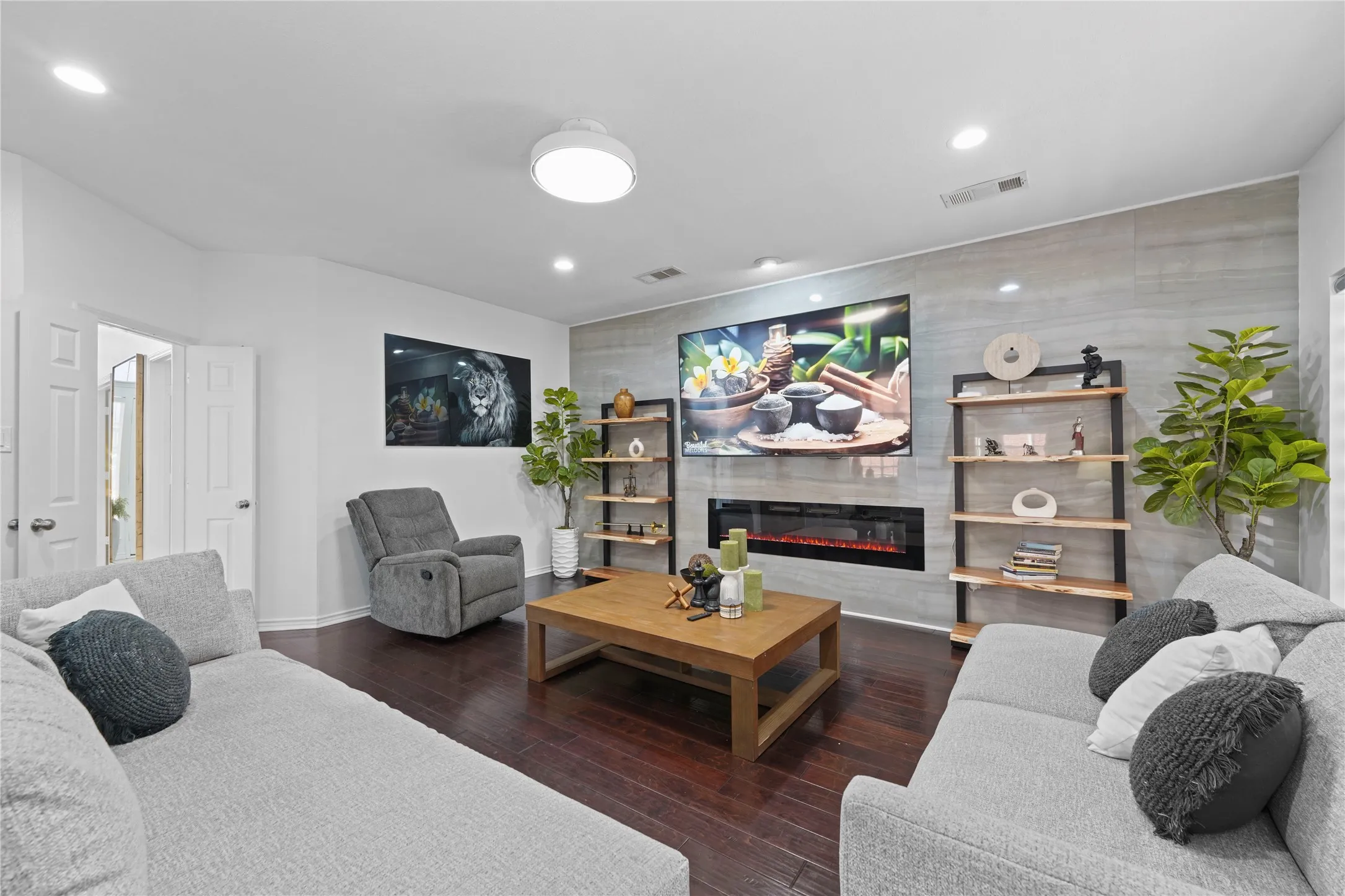 Living area featuring dark wood-finish flooring and recessed lighting