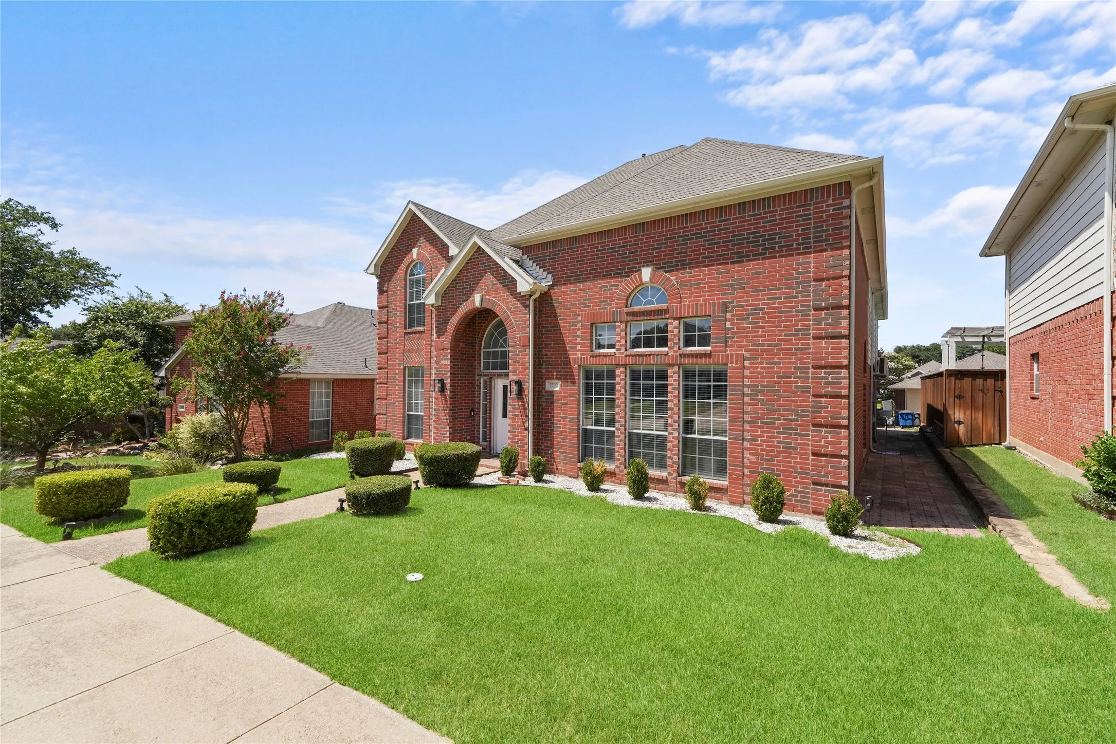 Brick exterior with a gabled roofline and arched entryway