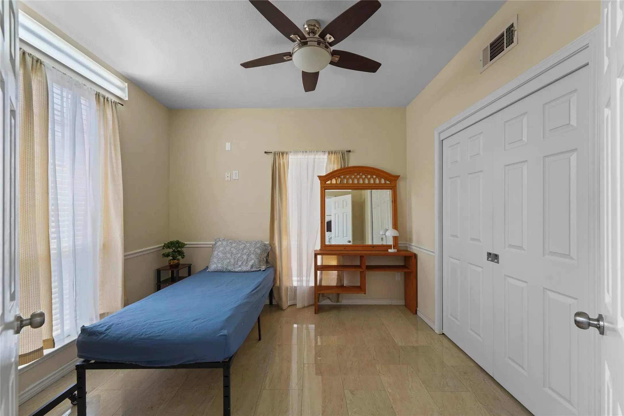 Room featuring light-toned flooring, a ceiling fan with integrated lighting, and neutral wall paint