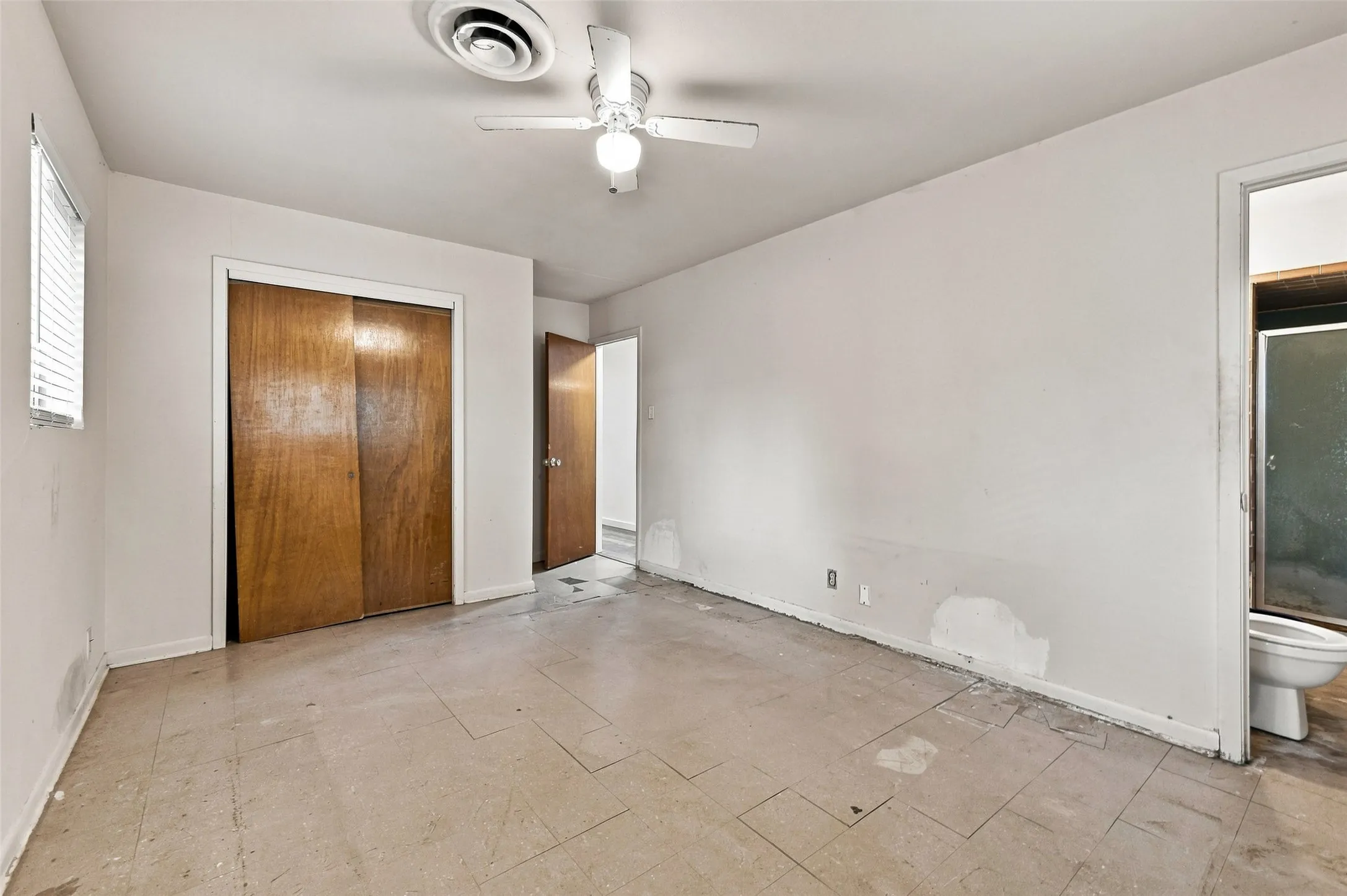 Room featuring a ceiling-mounted fan, recessed lighting, and wood-finish sliding closet doors