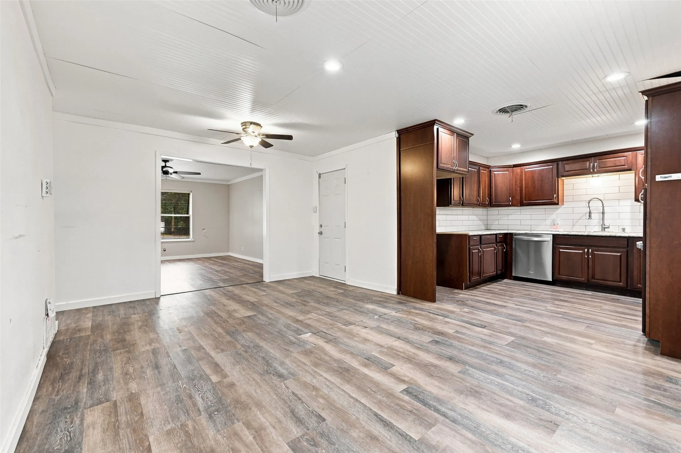 Wood-finish flooring throughout, recessed lighting, ceiling fan, and white beadboard ceiling