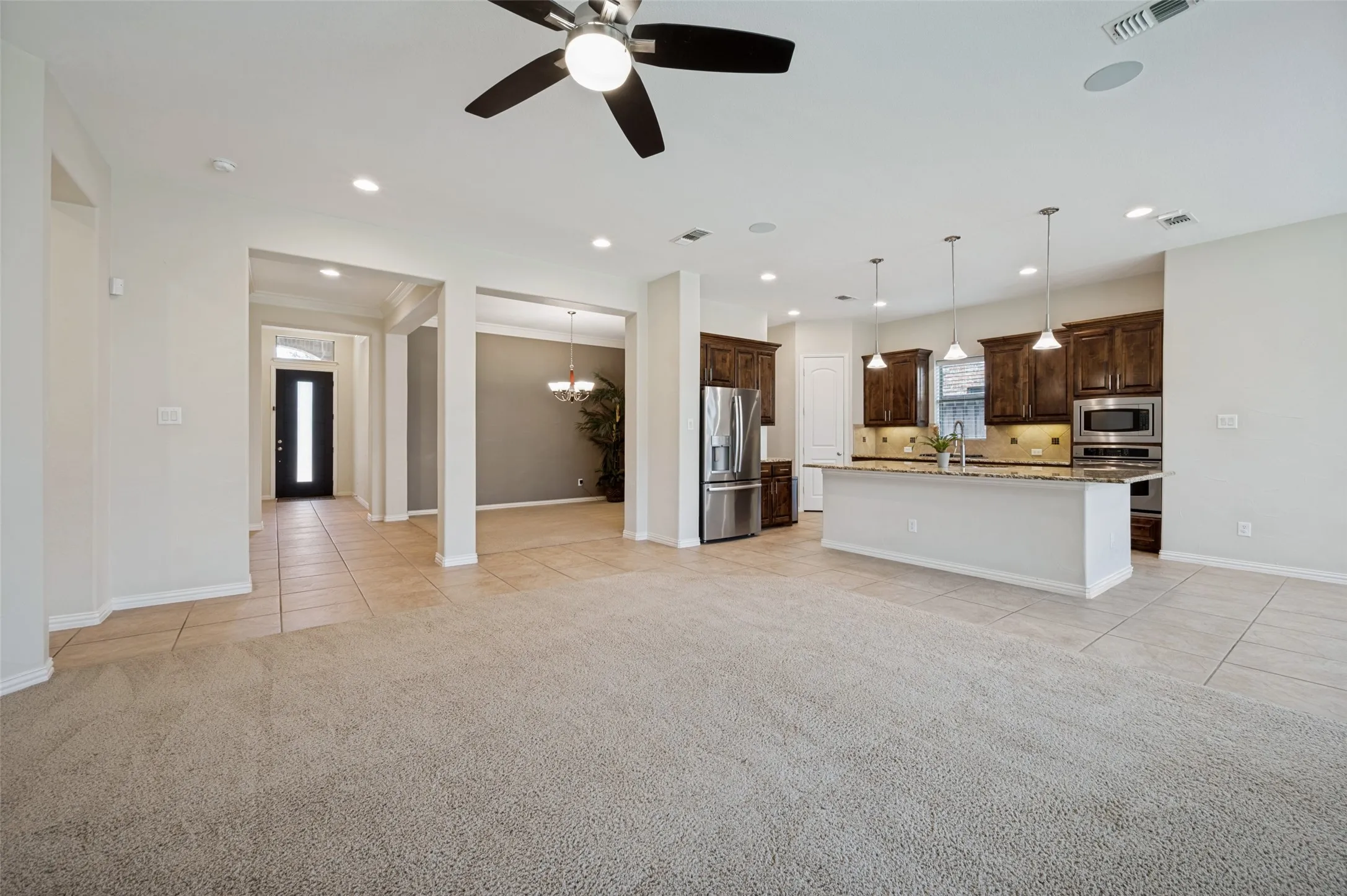 The heart of the home features a bright, open-concept layout where the living room, kitchen, and breakfast area flow seamlessly together.