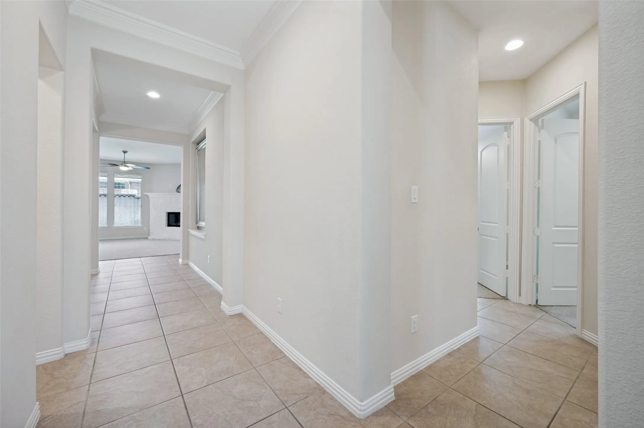 The thoughtfully designed entryway welcomes you with soaring ceilings, elegant crown molding, and timeless tile flooring that flows seamlessly into the main living areas.