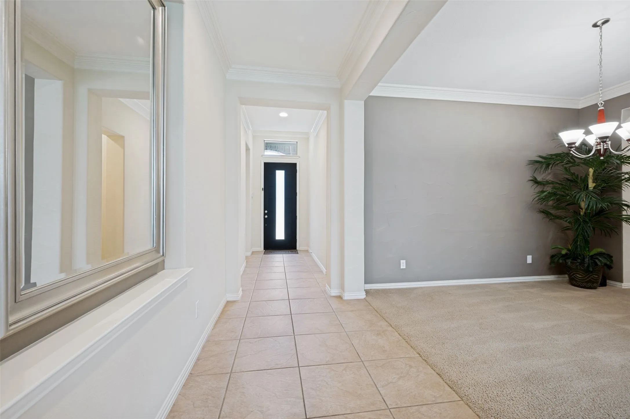 Step inside to a bright and inviting entry where soaring ceilings, abundant natural light, and elegant crown molding create an impressive first impression.
