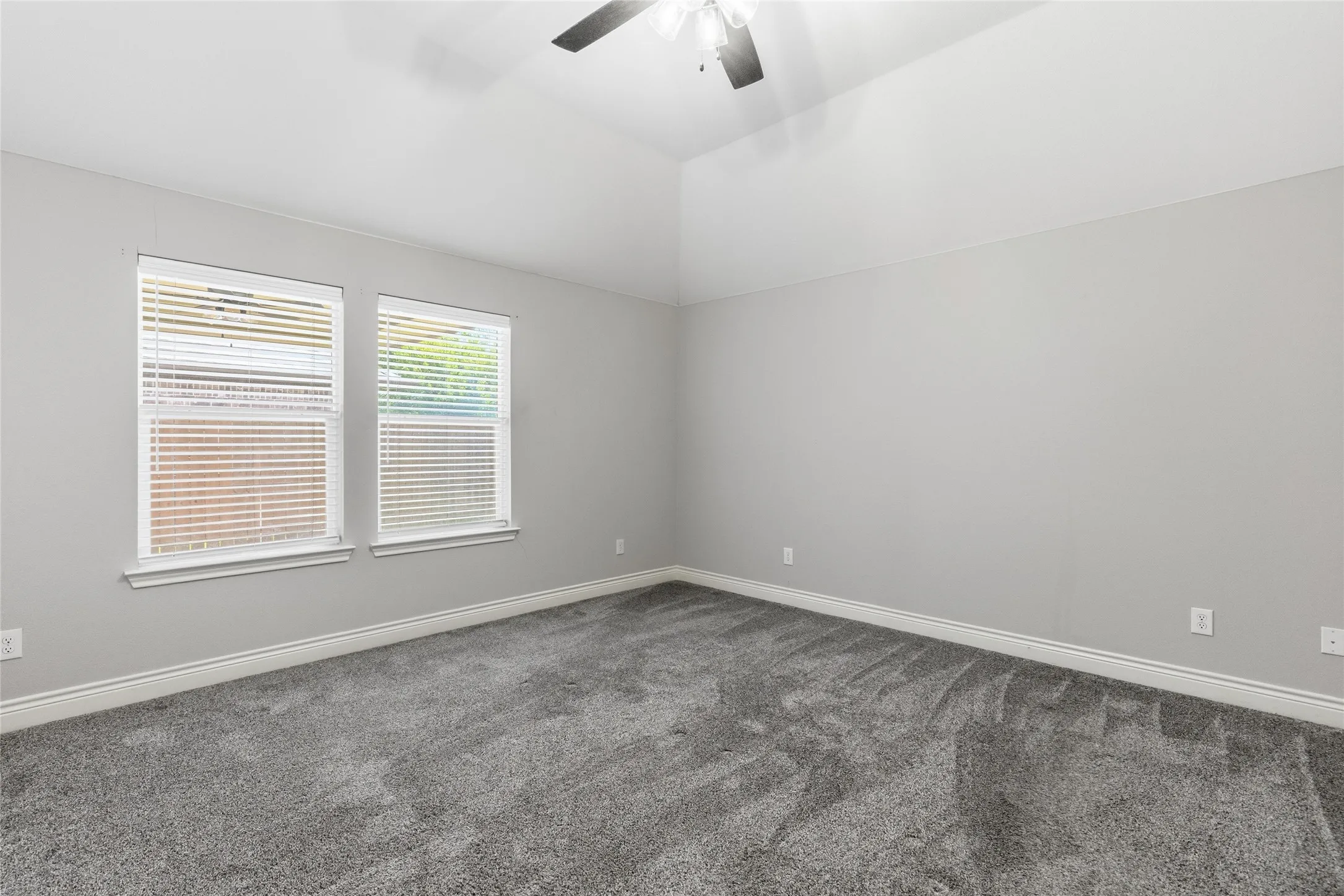 Room featuring neutral gray walls and gray carpeting