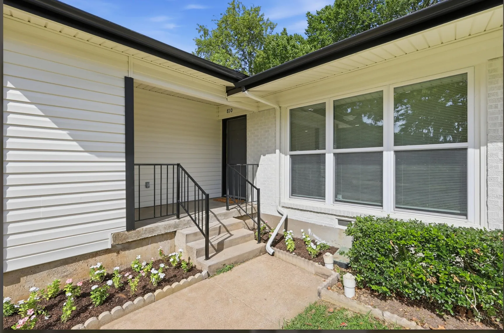 Exterior facade featuring white siding and white painted brickwork