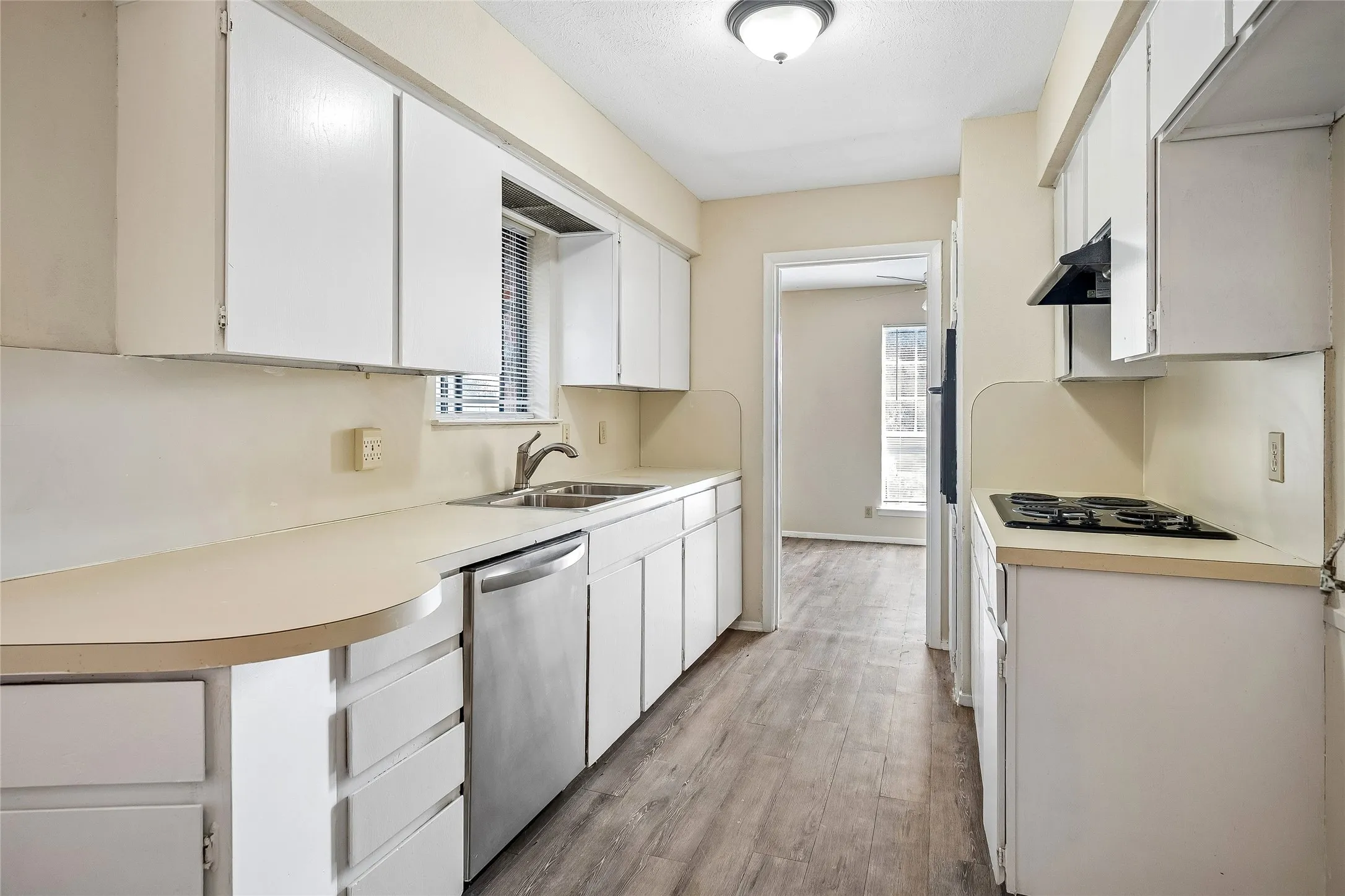 Nice kitchen with plenty of cabinet & countertop space with appliances including a stainless dishwasher, an electric cooktop and built-in oven.