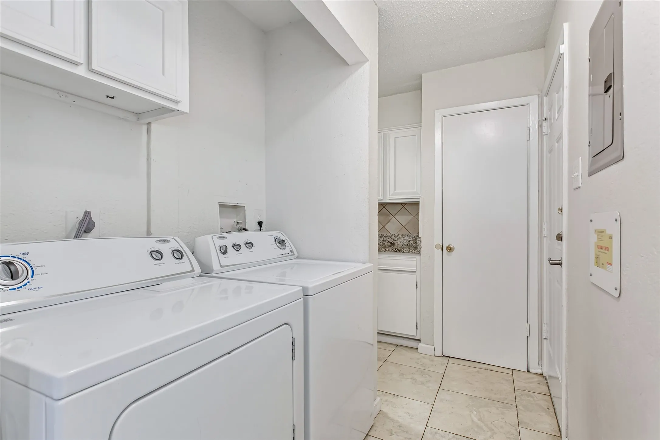 Efficient utility area with full-size washer and dryer which will convey with the property.