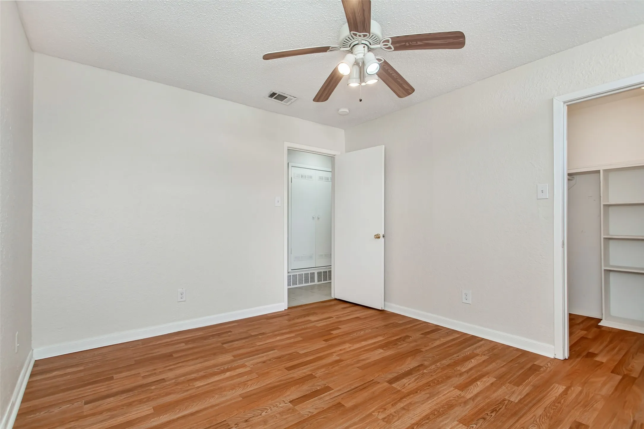 The secondary bedroom offers flexibility as a guest room, home office, or hobby space