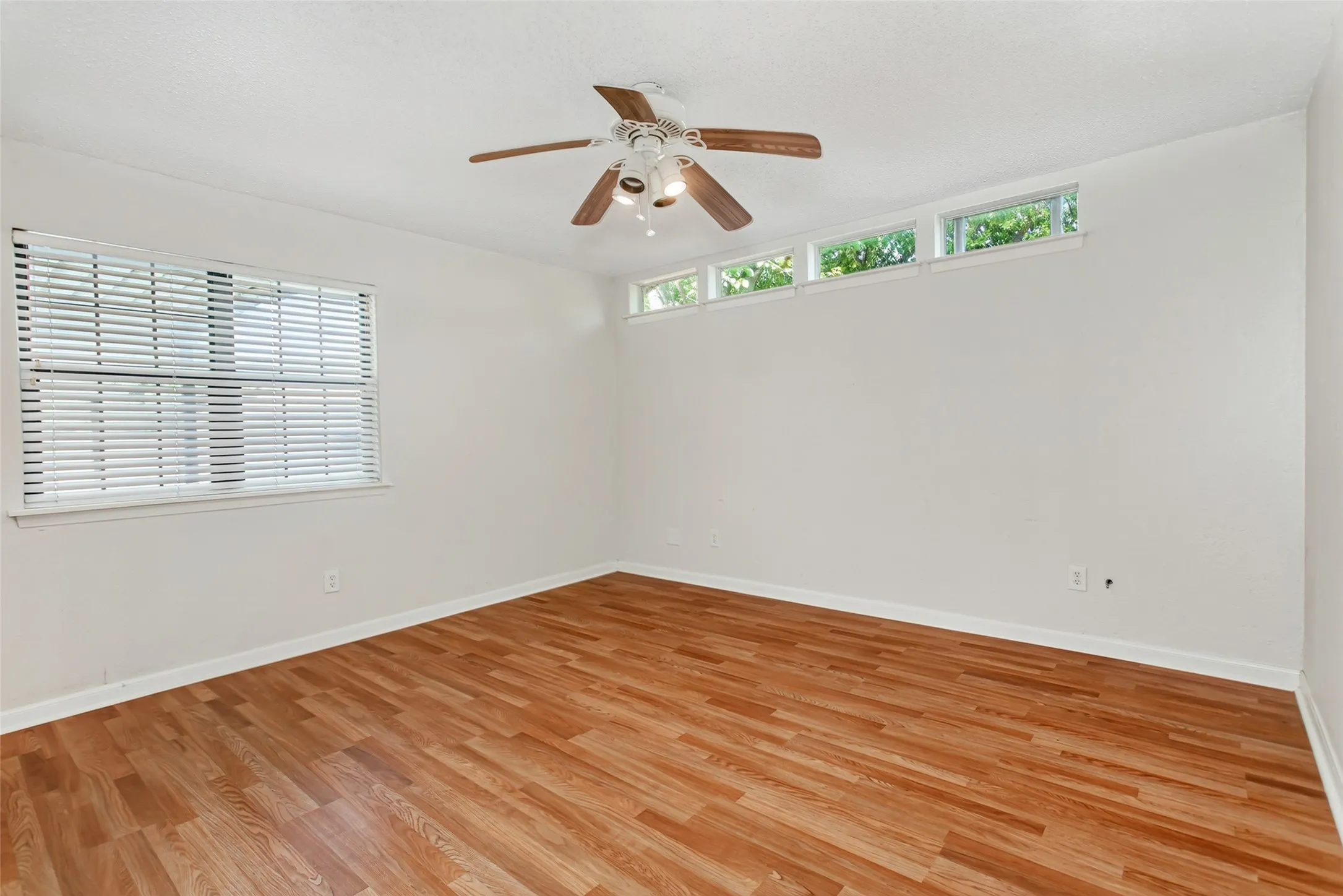 Primary Bedroom features high transom windows.