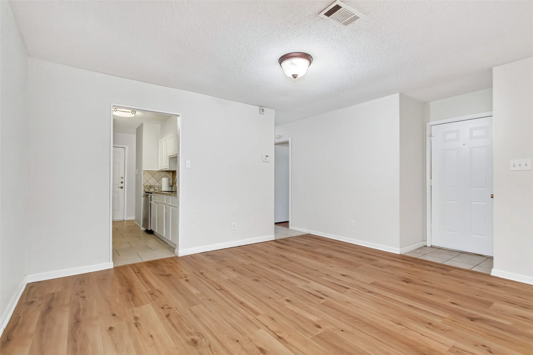 Open-concept living area flows seamlessly into dining area & kitchen from front entry.