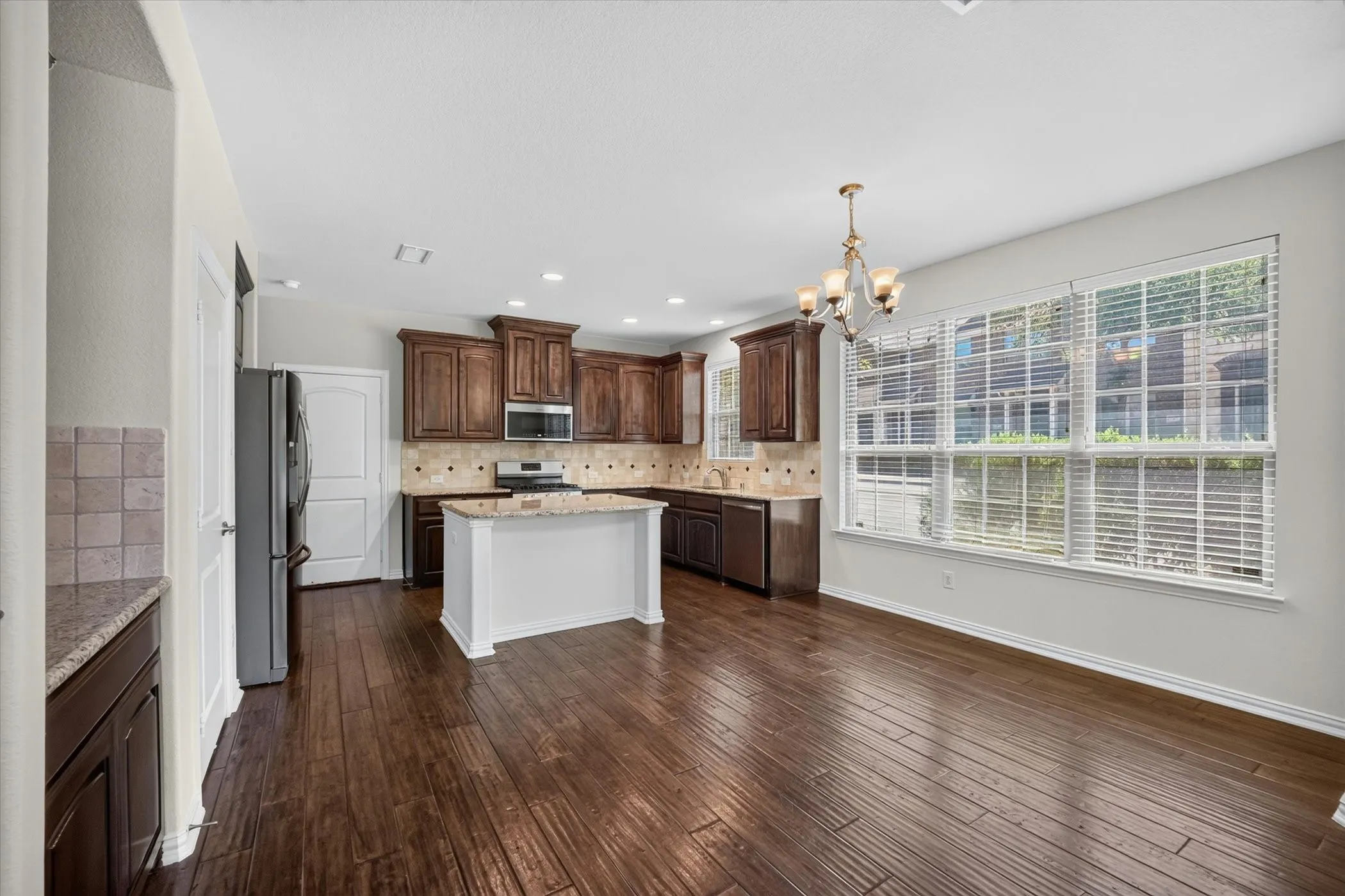 Kitchen and dining area featuring wood-finish flooring
