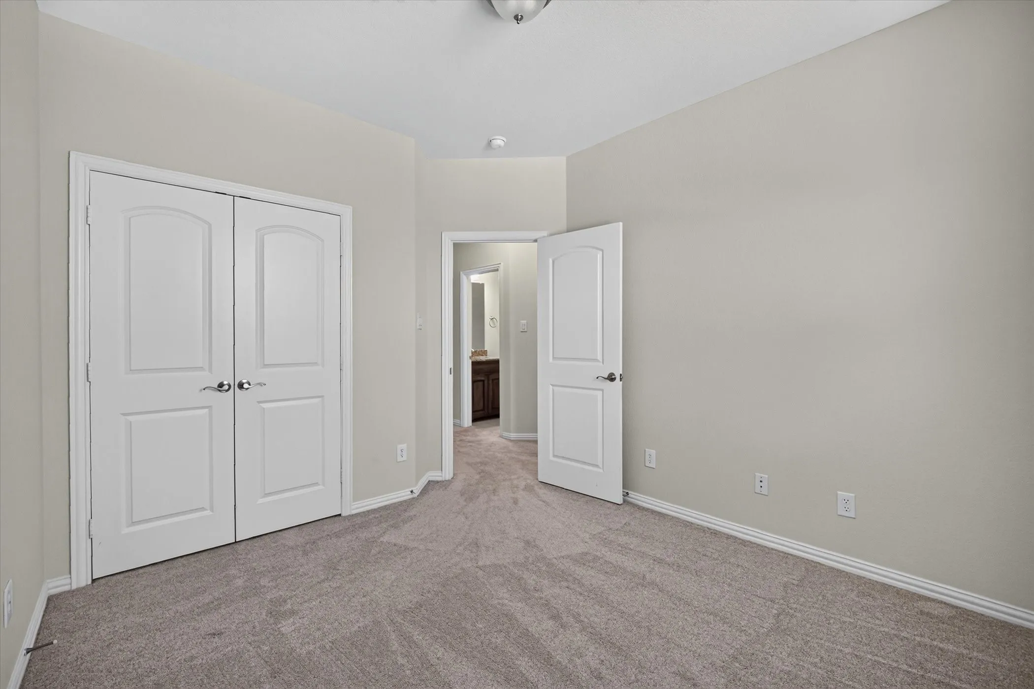Room featuring neutral gray wall paint and gray carpet flooring