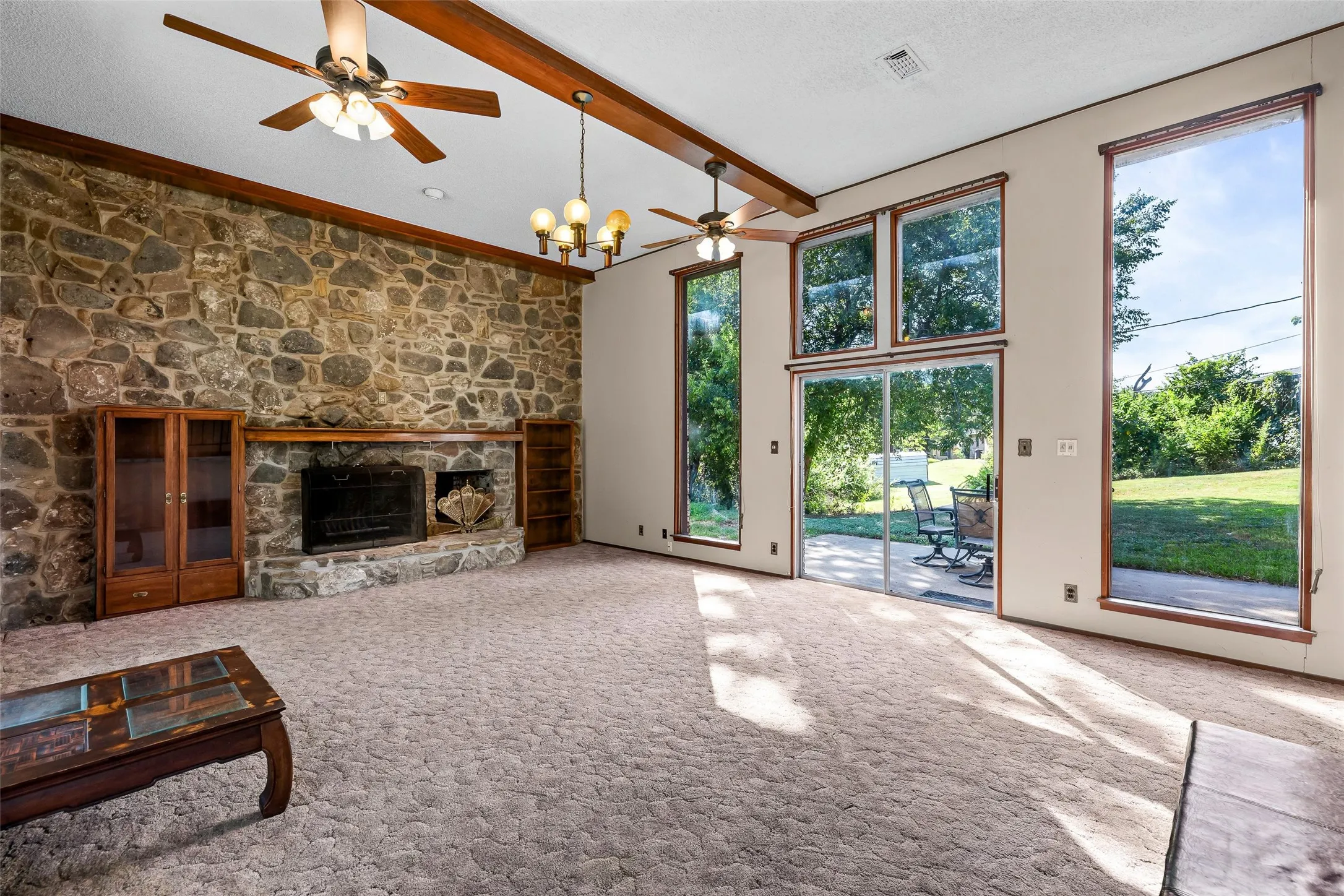 Large showcase windows with view of backyard.
