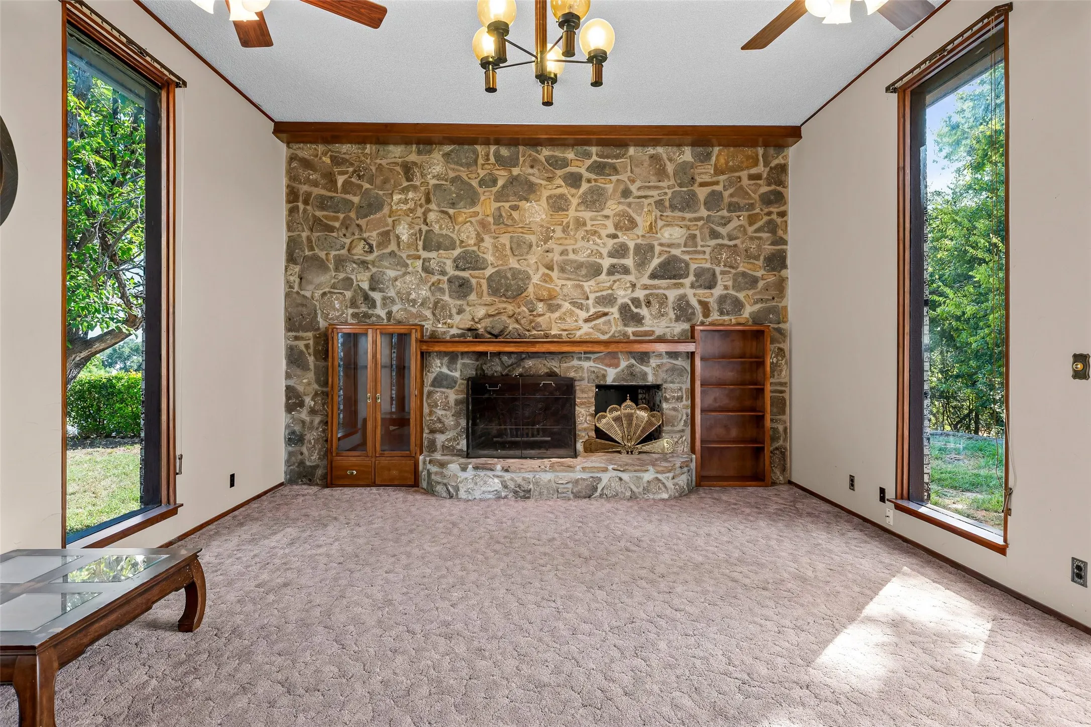 Spacious living room. Floor to ceiling native rock fireplace.With built ins