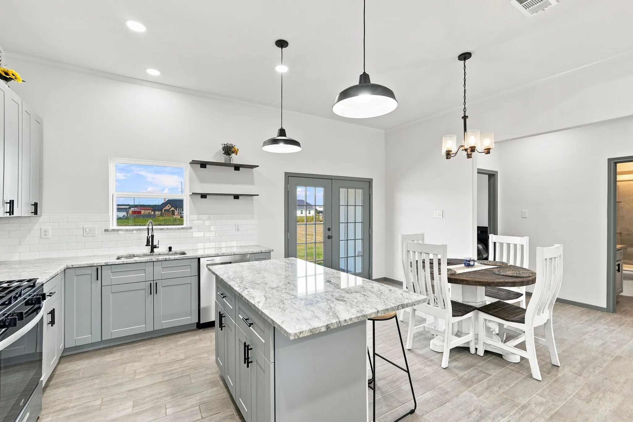 Stunning kitchen featuring a large island and cabinetry, opening seamlessly to the dining area, perfect for connecting with family.