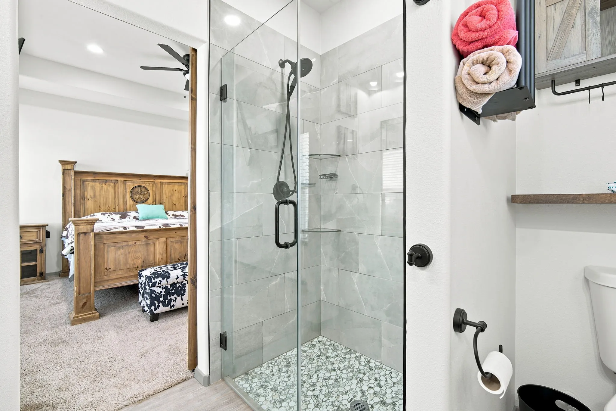 Primary bathroom featuring a beautifully tiled, glass-enclosed walk-in shower, a spa-like retreat.