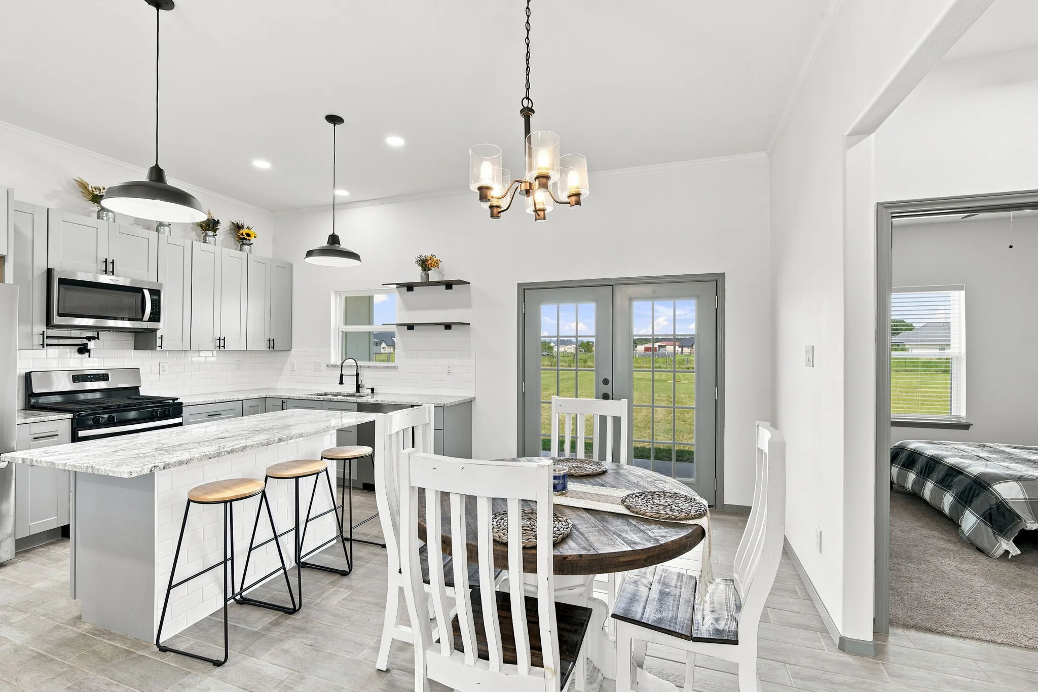 Open kitchen with an island, offering great sightlines into the dining and living areas for effortless entertaining.
