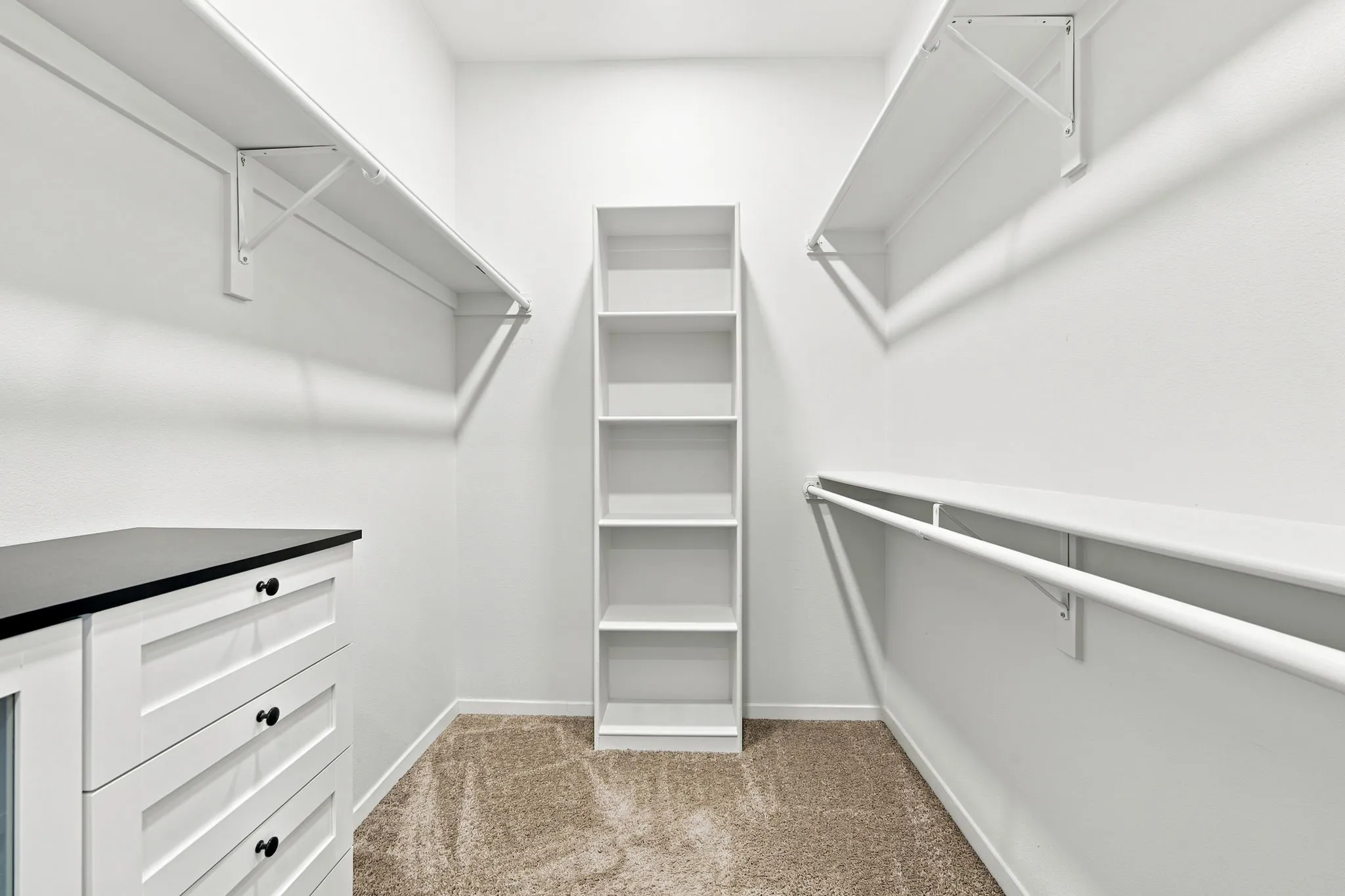 Impressive walk-in closet with built-in shelving and drawer storage, ready to organize it all.
