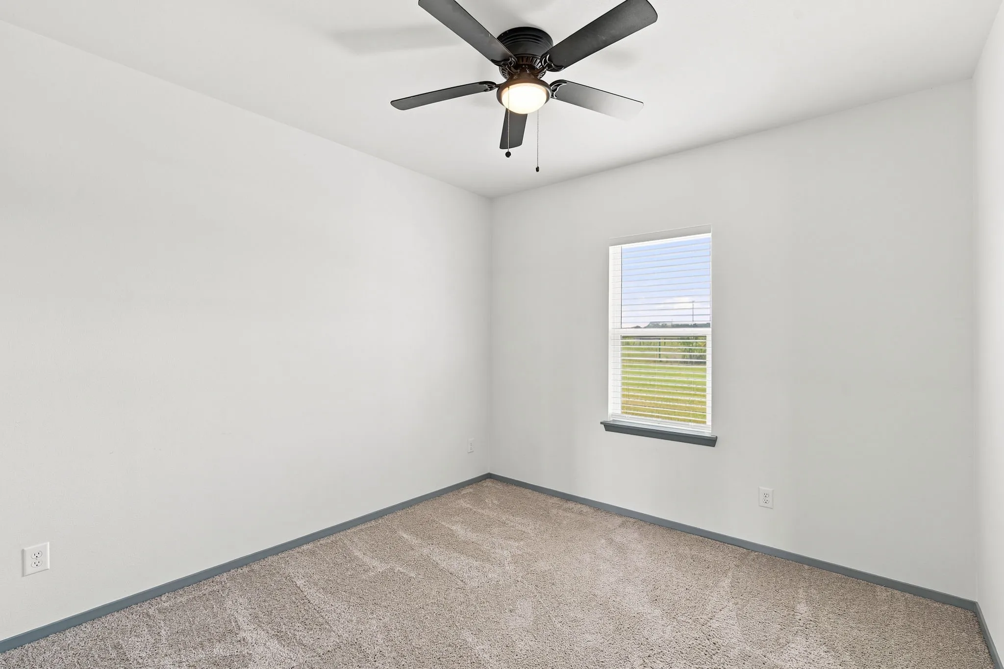 Bright bedroom with a window overlooking the yard, offering a cozy space to call your own.