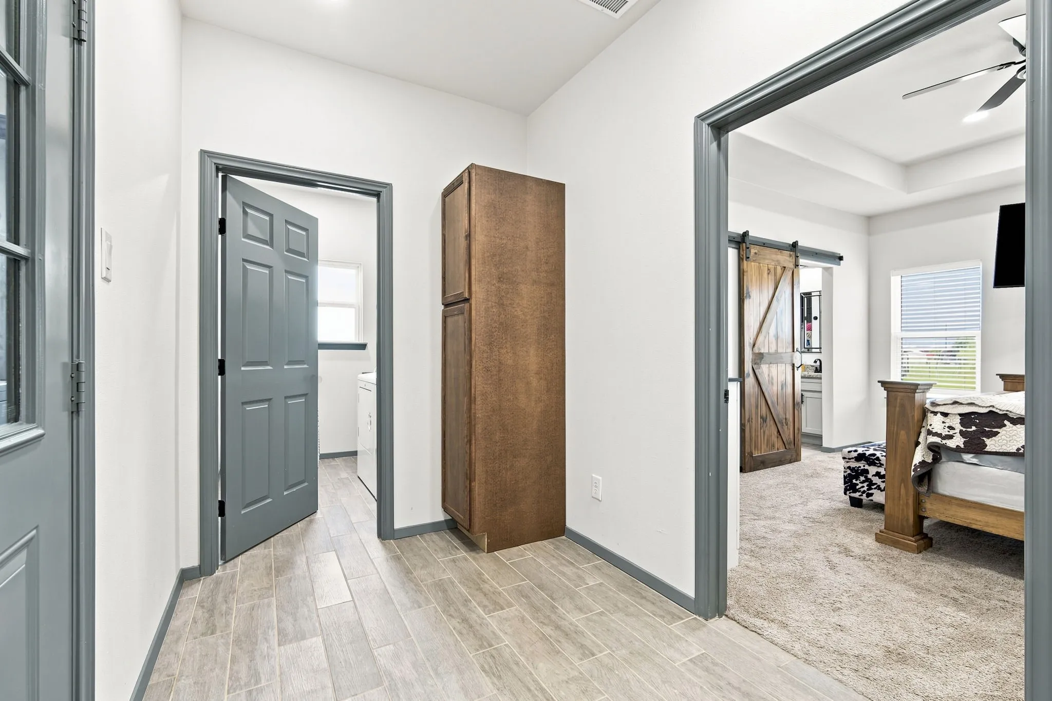 Convenient hallway with built-in storage, connecting easily to additional rooms throughout the home.