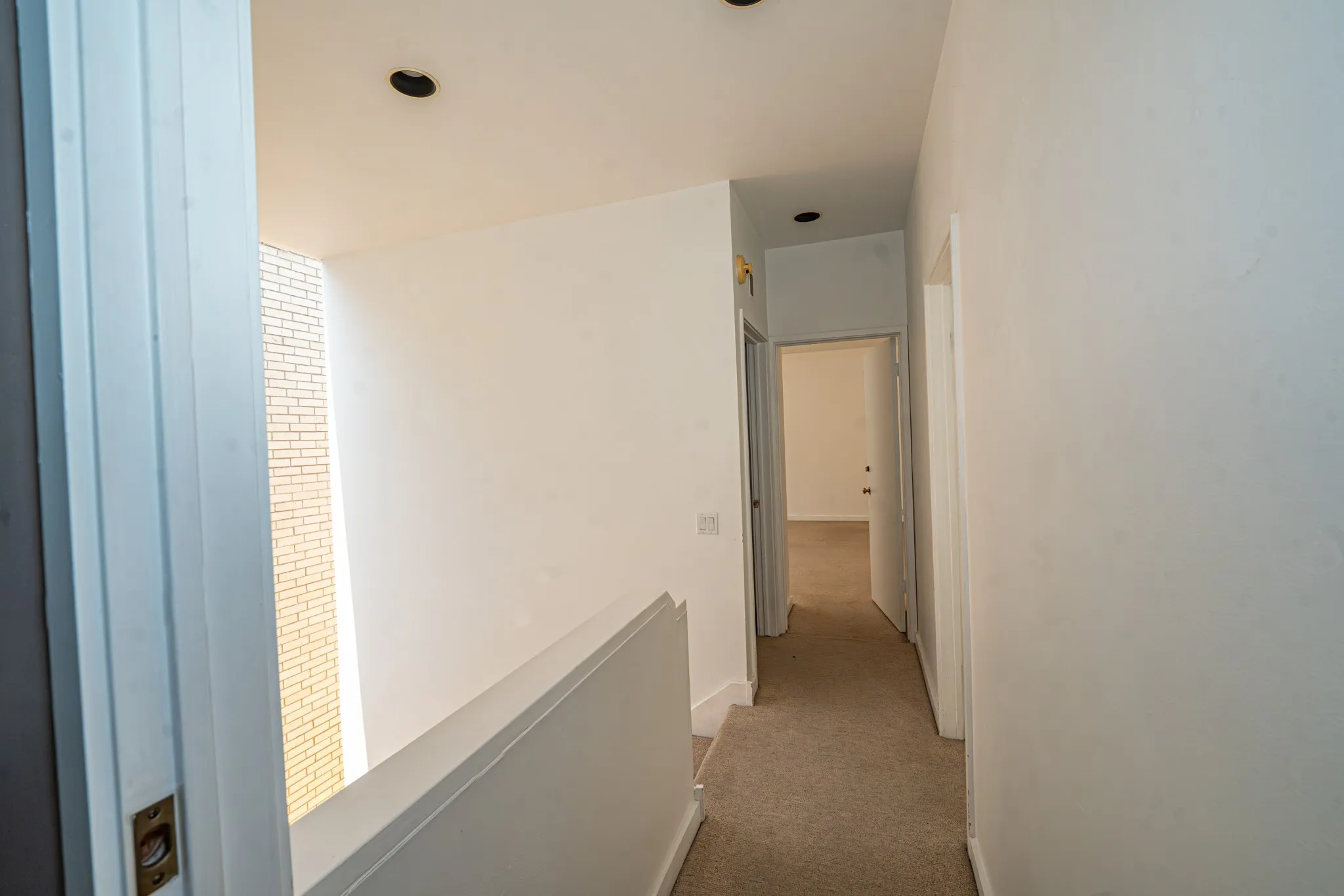 Carpeted hallway with white walls, recessed lighting, and white trim turn right and go to one bedroom and turn left for second bedroom