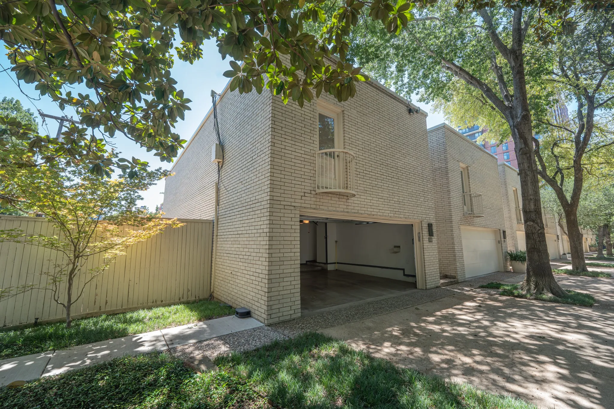 Cream brick exterior featuring an integrated two-car​​‌​​​​‌​​‌‌​‌‌​​​‌‌​‌​‌​‌​​​‌​​ garage