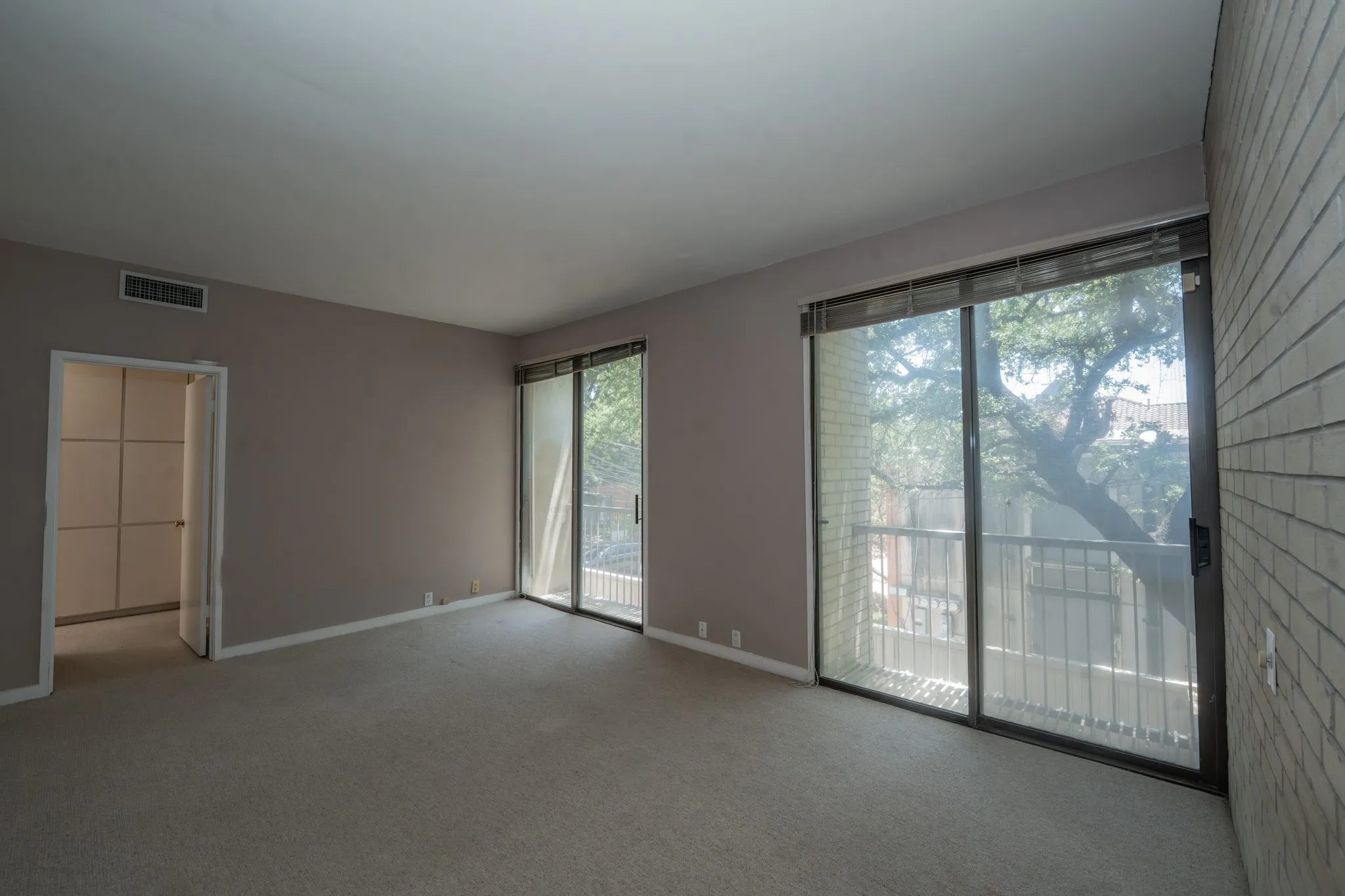 Large bedroom with natural light shine through. There is room for sitting area