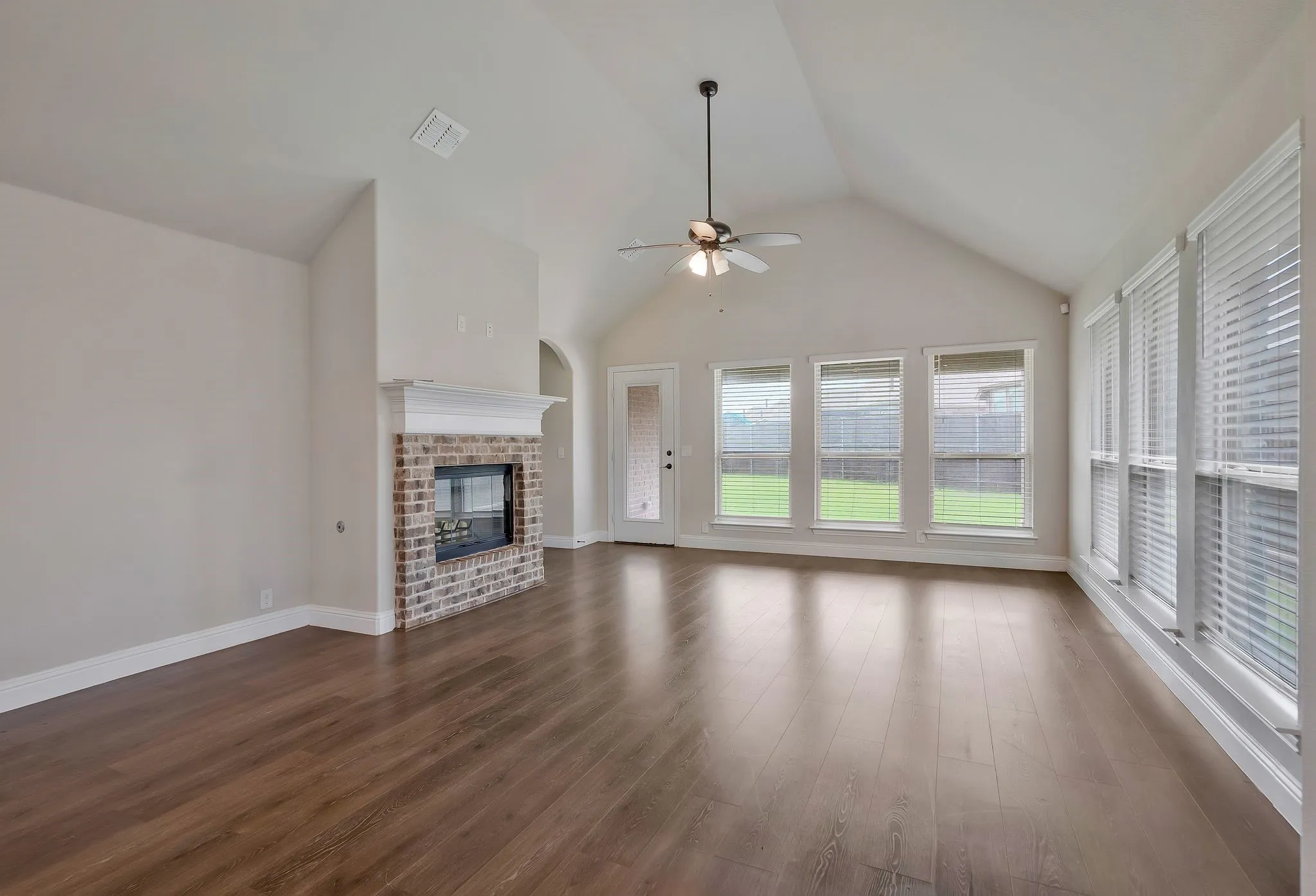 The living room includes a cozy fireplace and opens to the covered patio.