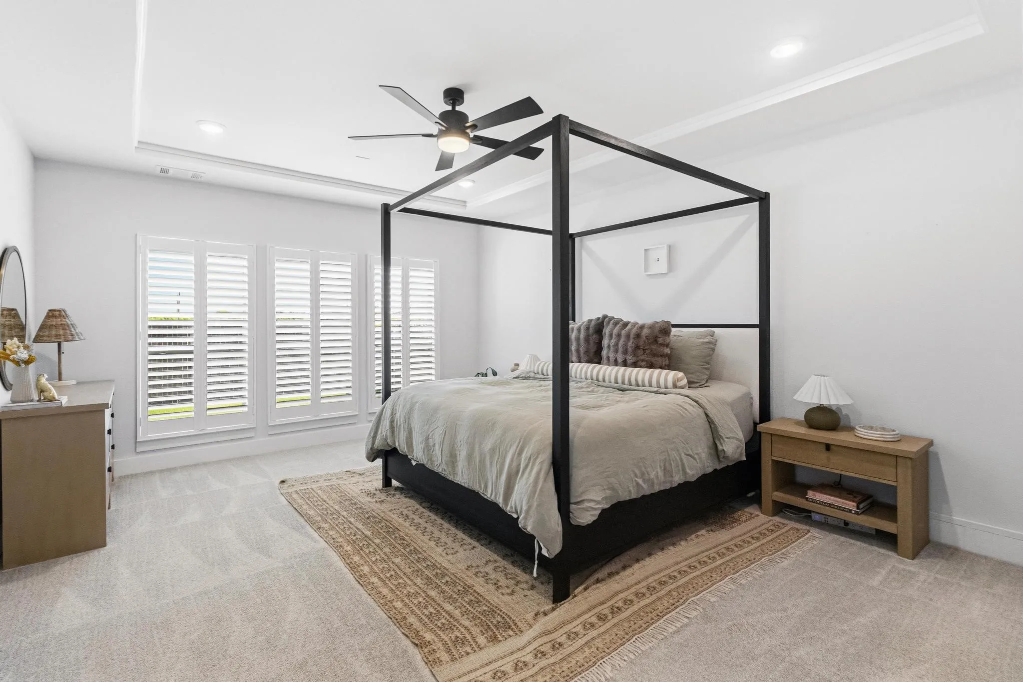 Spacious room featuring light gray carpeting and white walls