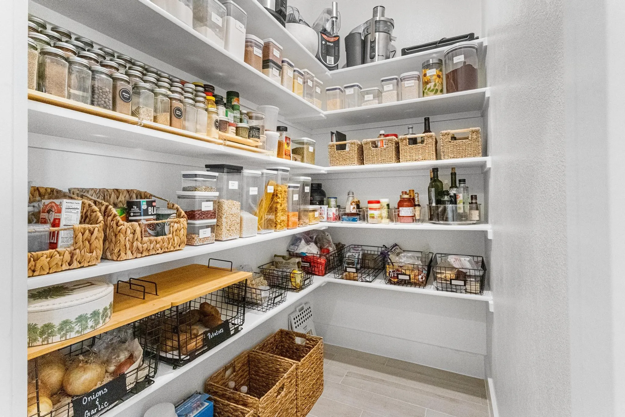 Walk-in pantry featuring extensive white shelving