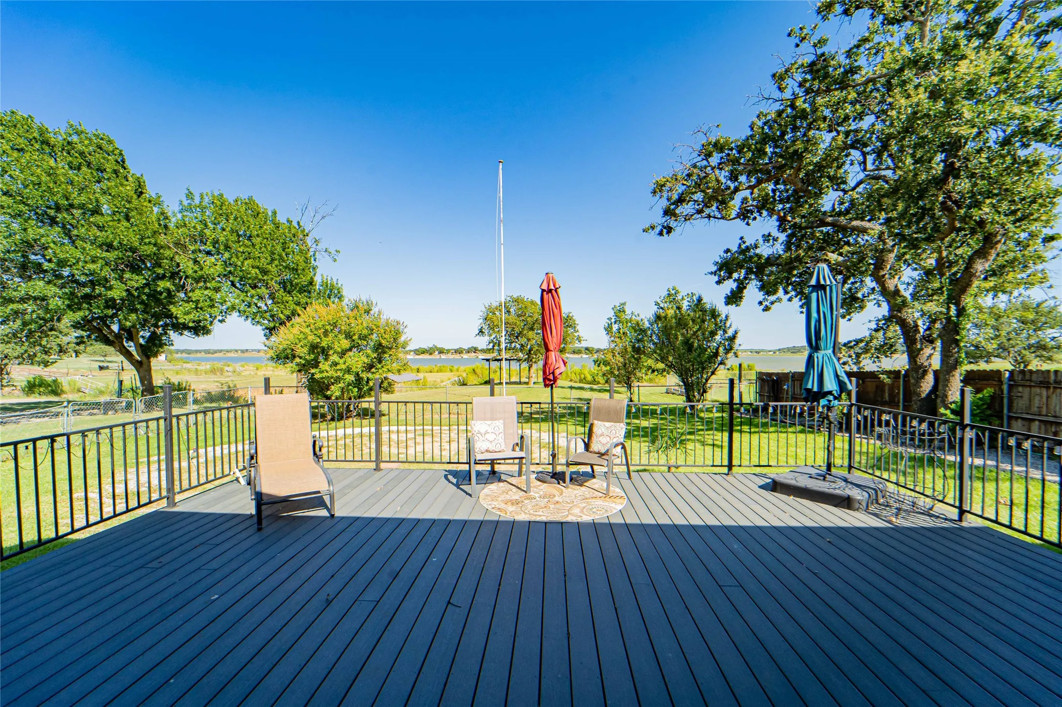 Spacious outdoor deck with dark composite decking and black metal railings