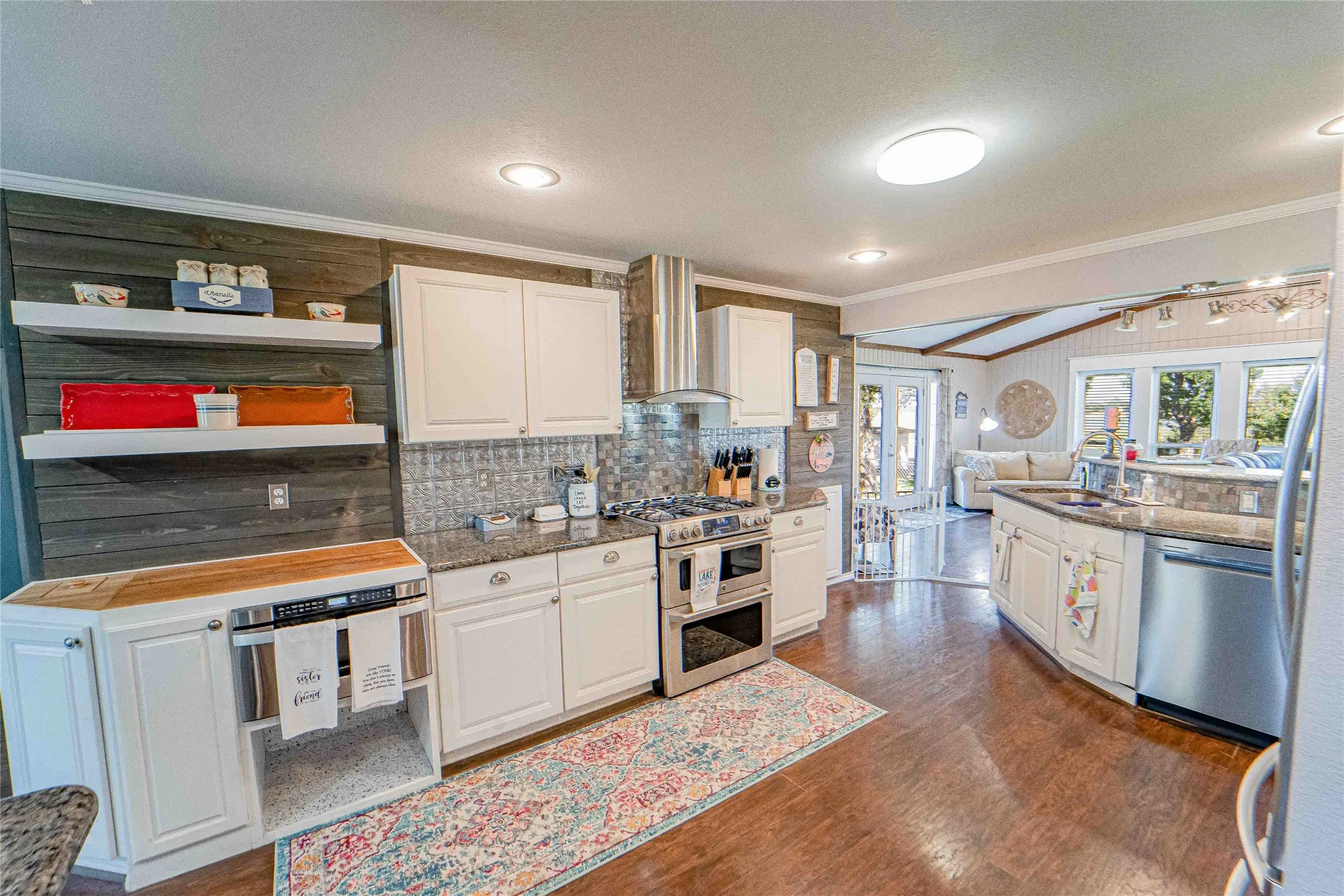 Light and bright-Kitchen with white cabinetry, wood-finish flooring, and recessed lighting