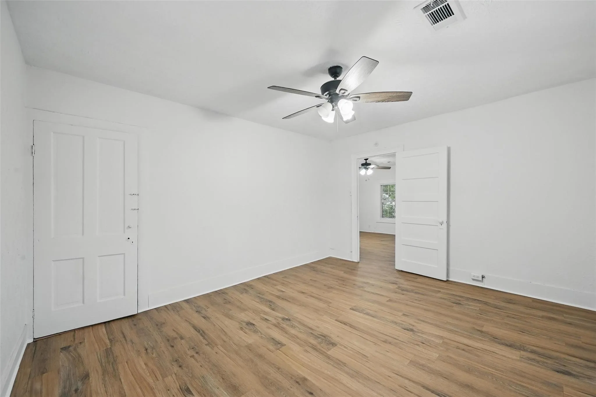 Unfurnished room featuring wood finished floors and baseboards