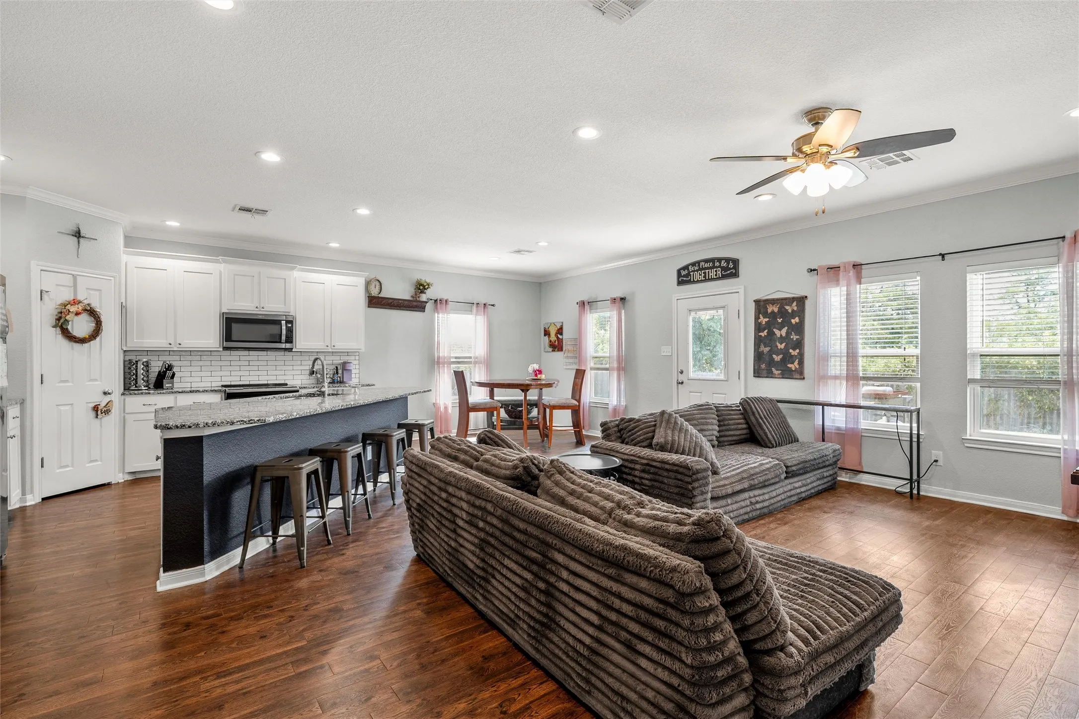 Open-concept living space featuring wood-finish flooring throughout