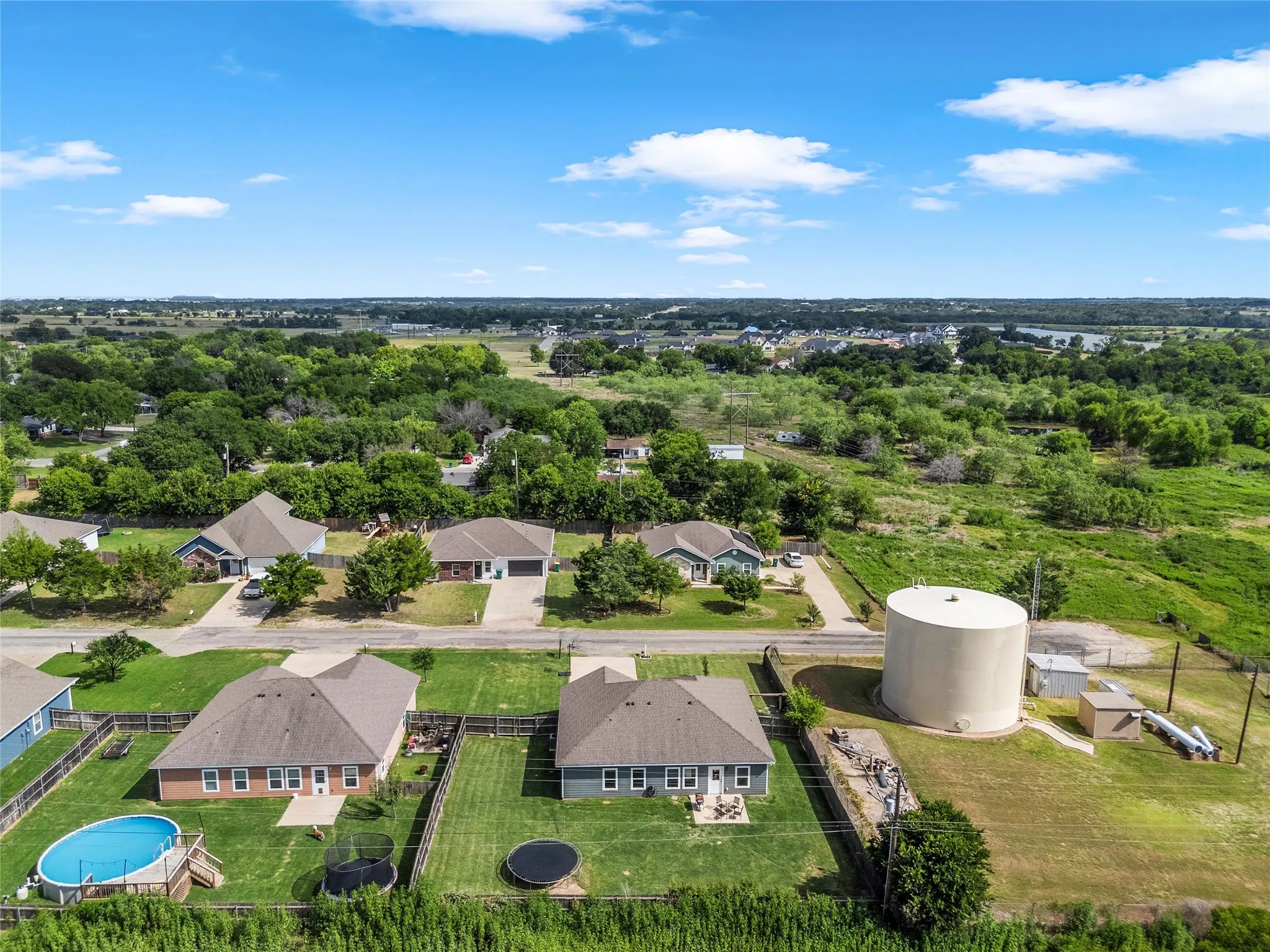 Neighborhood setting featuring residential properties with private yards and surrounding green spaces