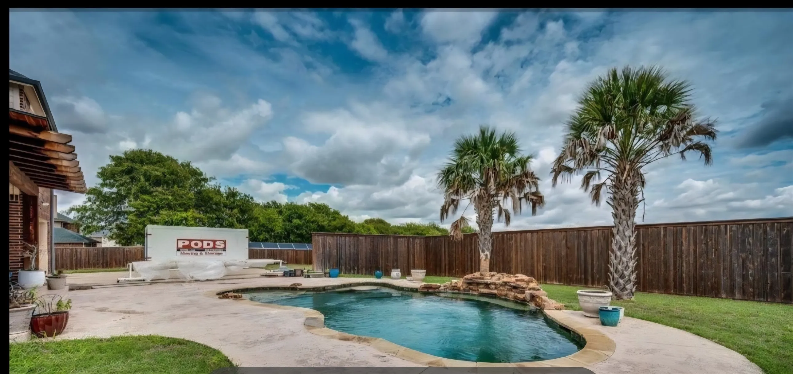 POOL SITS IN AN ENORMOUS YARD WITH PRIVACY FENCING FOR SWIMMING